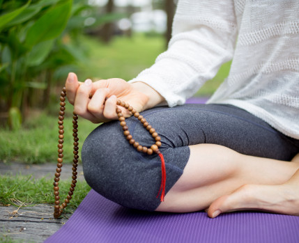 mulher a meditar num jardim