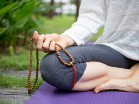 mulher a meditar num jardim